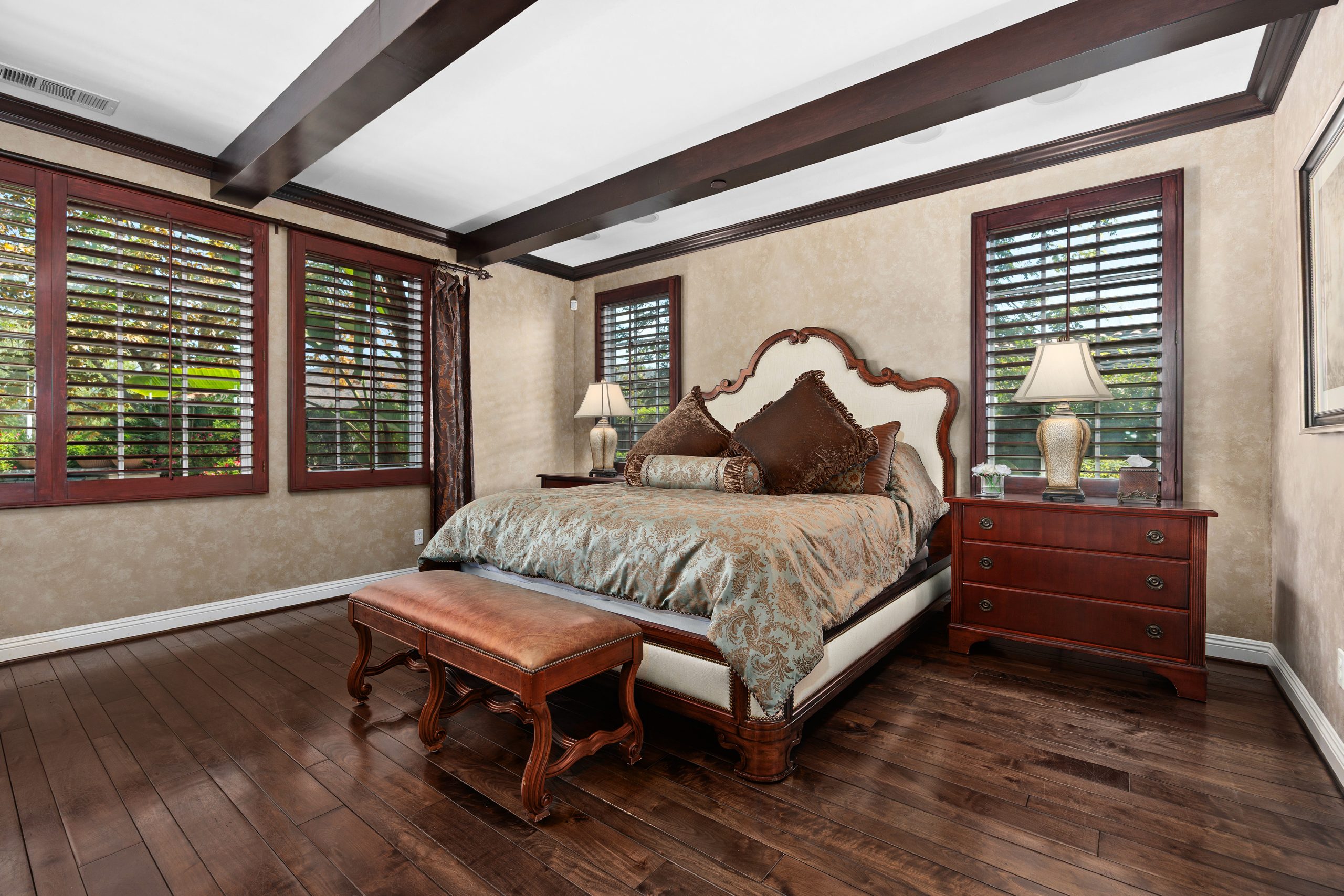 First-floor primary bedroom suite with sitting area and fireplace